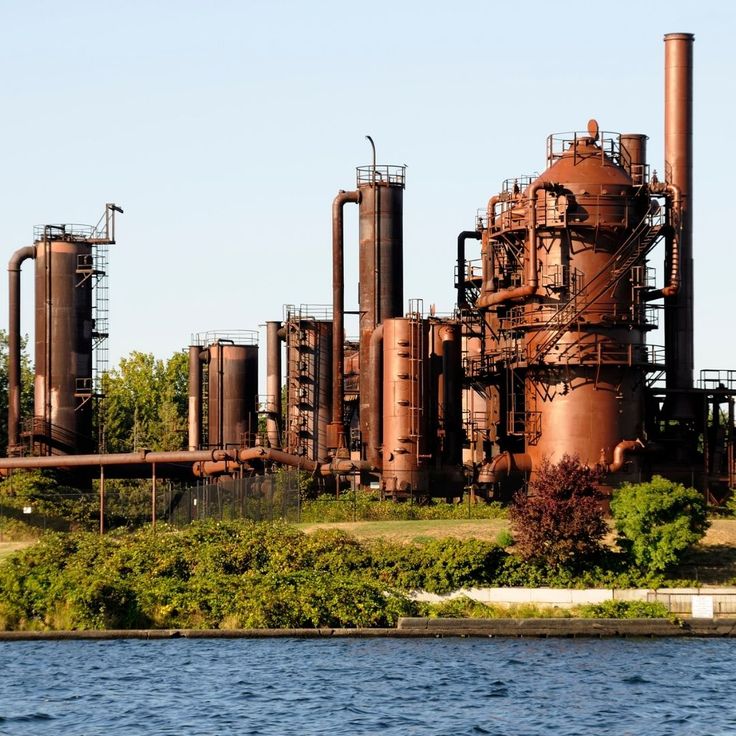 an old factory near the water on a sunny day