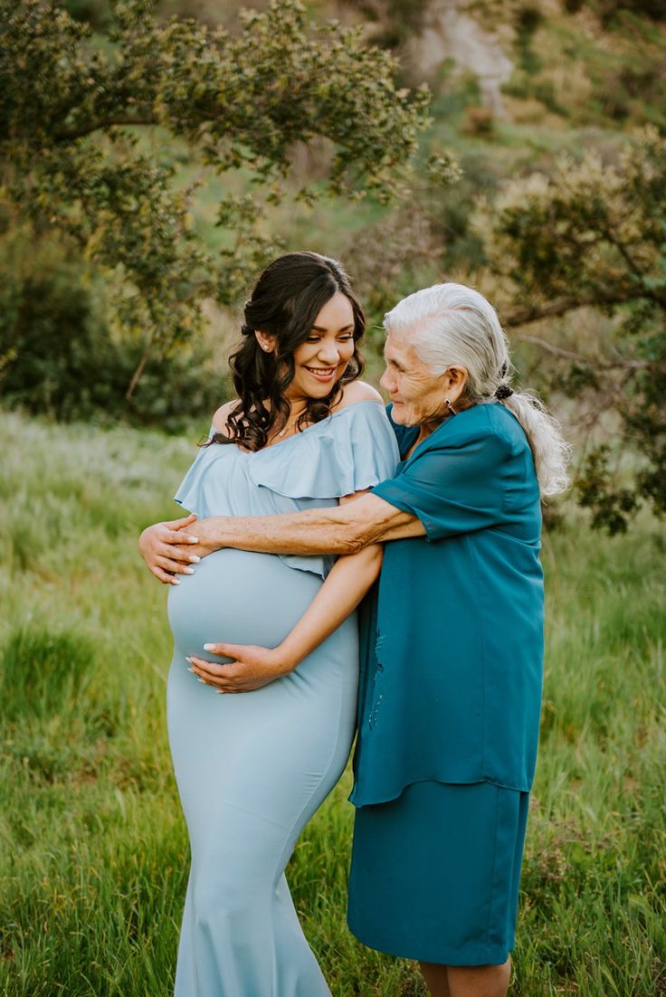 an older woman hugging her pregnant mother