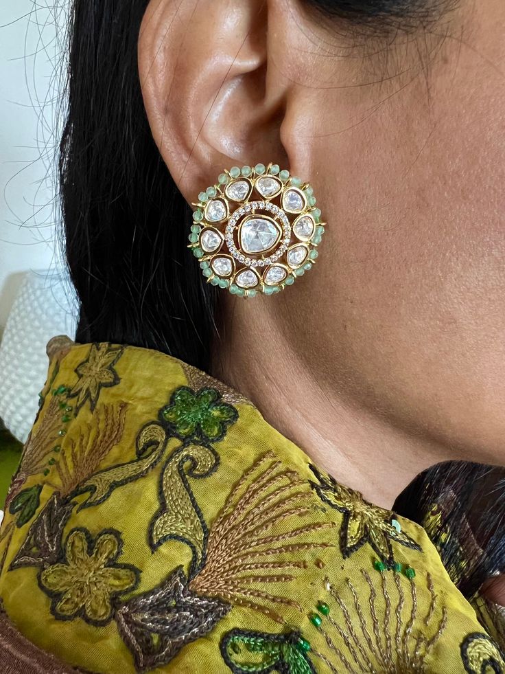 Restocked ♥️ On popular demand  This gorgeous Bridal Studs will add a perfect charm to your festive wear. One of our favorite picks for the wedding season  The diameter of the studs is 3cms. The weight of the studs is 12 grams per pair. Notice the zirconia stones bordering the center Kundan piece. Premium Quality Colour: Mint Green Kundan Earrings With Zari Work, Round Kundan Earrings With Zari Work, Gota Work Bridal Earrings For Reception And Festivals, Festive Bridal Earrings With Meenakari For Reception, Elegant Gold Kundan Necklace With Dori Work, Kundan Bridal Earrings With Zari Work For Celebrations, Wedding Chandbali Jhumkas With Dori Work, Chandbali Jhumkas With Dori Work For Wedding, Bollywood Style Gota Work Earrings For Reception