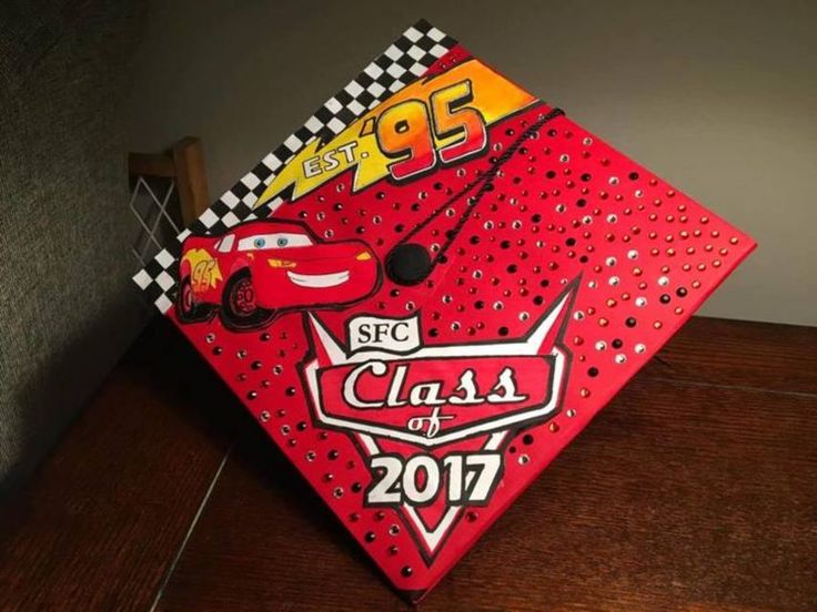 a red graduation cap with cars on it