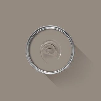 a can of paint with a shadow on the wall