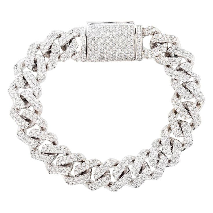 This bracelet is made in 14K white gold. The bracelet features 651 round cut, prong set diamonds weighing 10.71 carats with a color grade (G) and a clarity grade (VS2) and contains 107 grams of gold. Bling Ideas, Cuban Chain, Chain Link Bracelet, Diamond White, Link Bracelets, Chain Bracelet, Prong Setting, Chain Link, Diamond Bracelet