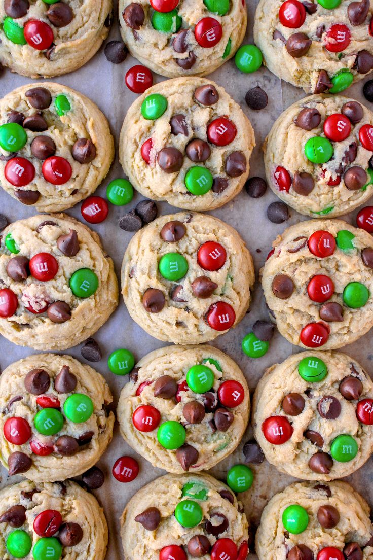 chocolate chip cookies with m & m candies and candy on top are arranged in rows