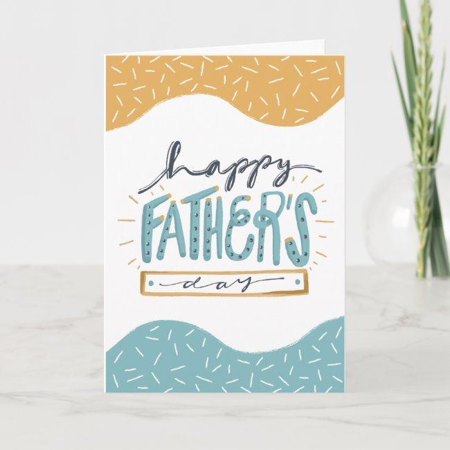 a father's day card sitting on top of a table next to a vase with flowers