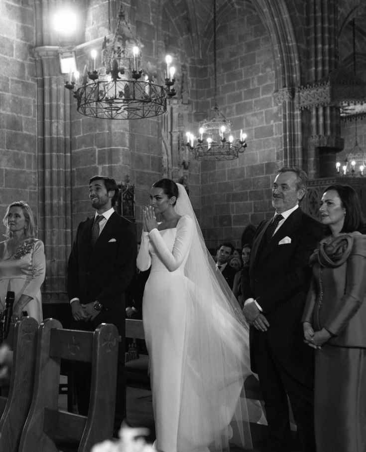 a bride and groom walking down the aisle at their wedding ceremony in black and white