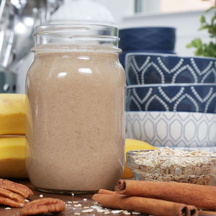 a glass jar filled with some kind of drink next to other food items and utensils