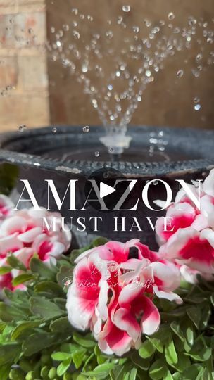 pink and white flowers in front of a water fountain with the words amazon mist have