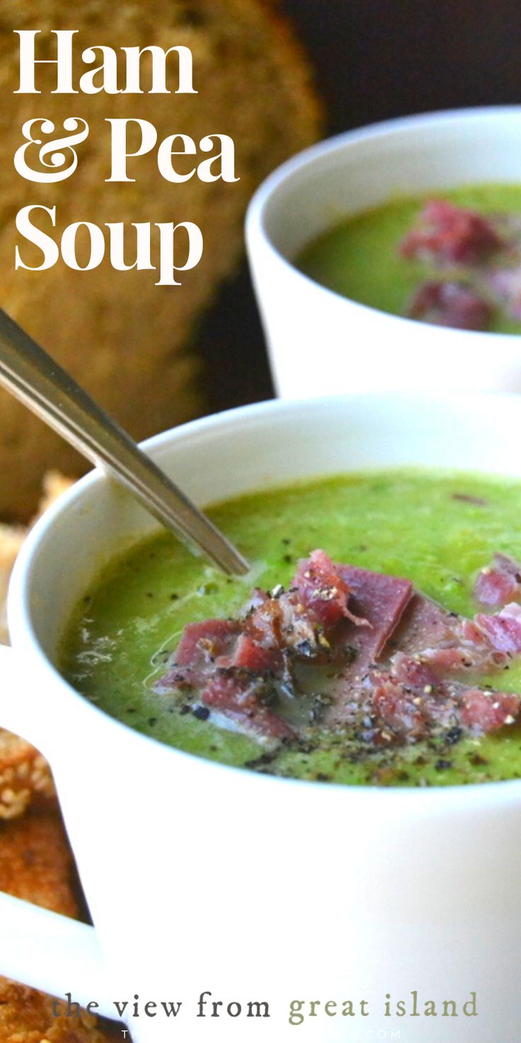 two bowls of ham and pea soup with bread in the background