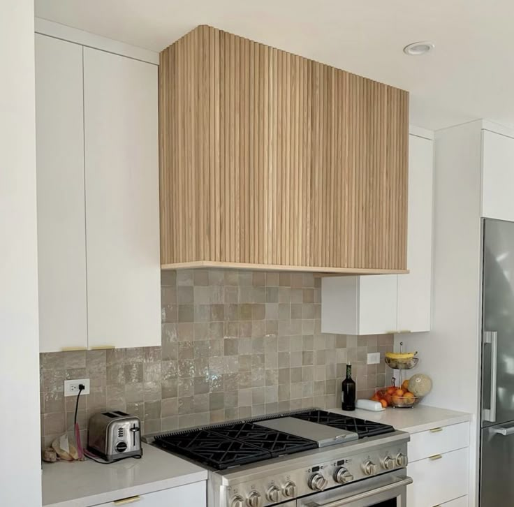 a stove top oven sitting inside of a kitchen