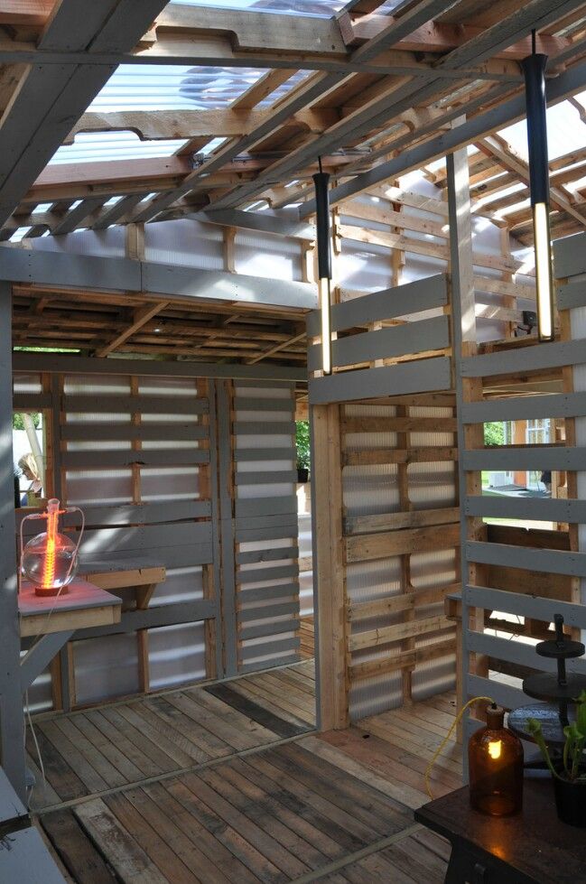 the inside of a house with wood slats on the walls and flooring in it