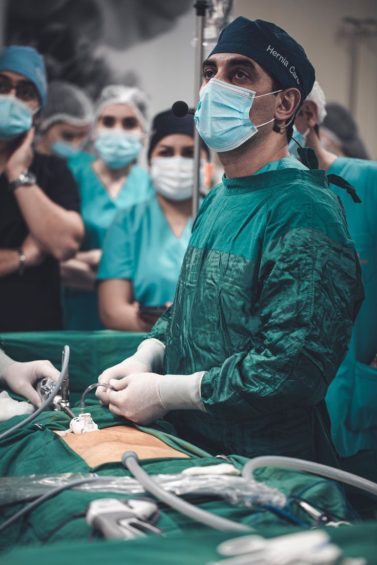 a group of doctors in scrubs and surgical masks