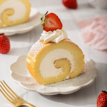 a piece of cake on a plate with strawberries