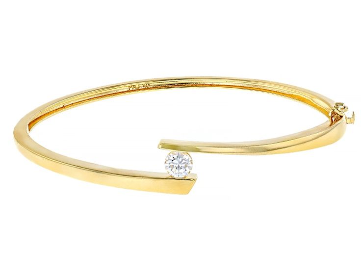 Pre-Owned Moissanite Fire® .60ct diamond equivalent weight round, 14k yellow gold over sterling silver bangle bracelet. Measures  approximately 7 & 1/4" L x 7/16" W. and has a  box clasp. Actual moissanite weight is .54ct. .  This product may be a customer return, vendor sample, or on-air display and is not in its originally manufactured condition.  It may not be new.  In some instances, these items are repackaged by JTV. Formal Diamond Bangle With Single Diamond, Formal Bangle With Single Diamond, Fine Jewelry Bangle With Single Diamond, Formal Fine Jewelry Bangle With Single Diamond, Modern Round Diamond Bracelet With Single Diamond, Yellow Gold Bangle With Single Diamond, Modern Yellow Gold Round Diamond Bracelet, Single Diamond Round Bracelet For Anniversary, 14k Gold Bracelet With Single Diamond