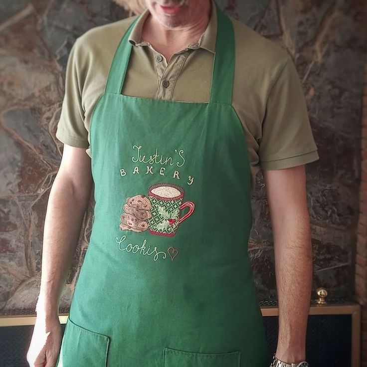 a man wearing an apron with a cup of coffee on it's front pocket