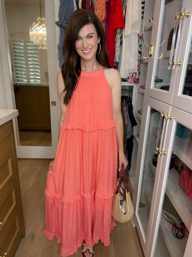 Get ready to dream of summer in our Summer Dream Maxi Dress! Made with lightweight, airy fabric, this gorgeous coral dress has that effortless feel and features a tiered body with ruffle trim. Add a slicked back ponytail or bun and pair with sandals or wedges for the perfect summer look. Carefree, chic, and easy - it's the perfect summer dress! This if fully lined. Strap length can be adjusted in the back. Dress measures 53" in length. Bust measures 22" from underarm seam to seam. Measurements taken on a small. Fabric has some give. This has a generous fit. Your normal size will be roomy throughout. If in between sizes or wanting a less loose fit, size down. Be sure to watch the fit video on the app for more information. FABRIC: 100% poly Heather is a 4 and 5'6" wearing a small. Back Ponytail, Fit Video, Slicked Back Ponytail, Coral Dress, Scarf Hat, Summer Dream, Summer Look, Hat Hairstyles, Ruffle Trim