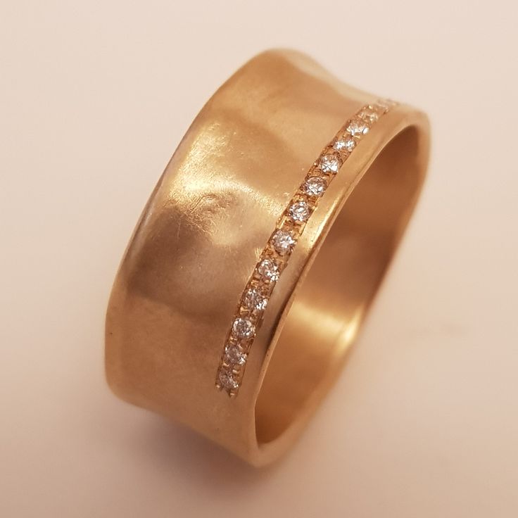 a close up of a gold ring with diamonds