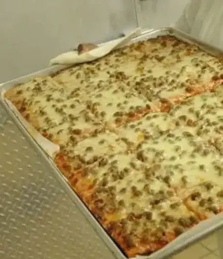 a pizza in a pan on top of a stove