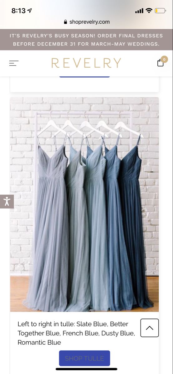 three dresses hanging on a rack in front of a white brick wall with the words revelry below it