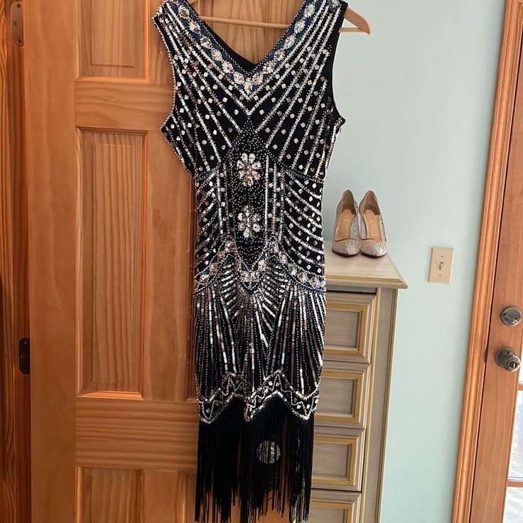 Perfect For A 1920s Party. Black And Silver Sequin Dress With Flapper Fringe. Beautiful And Never Worn. Nwt Black Sequined Art Deco Flapper Dress, Black Art Deco Flapper Dress With Sequins, Black 1920s Flapper Dress For Costume Party, Black Flapper Dress For Cocktail Events, Black Art Deco Dress For Costume Party, Black Cocktail Flapper Dress, Black Flapper Dress For Party, Art Deco Flapper Dress For Evening Parties, Black Art Deco Flapper Dress For Night Out