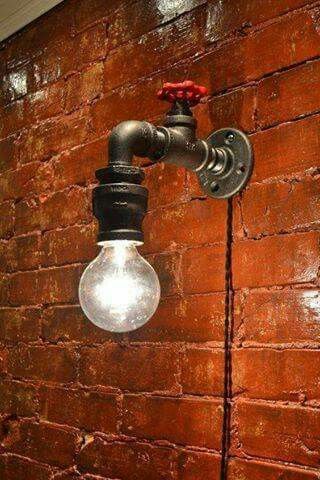 a light bulb is attached to a brick wall