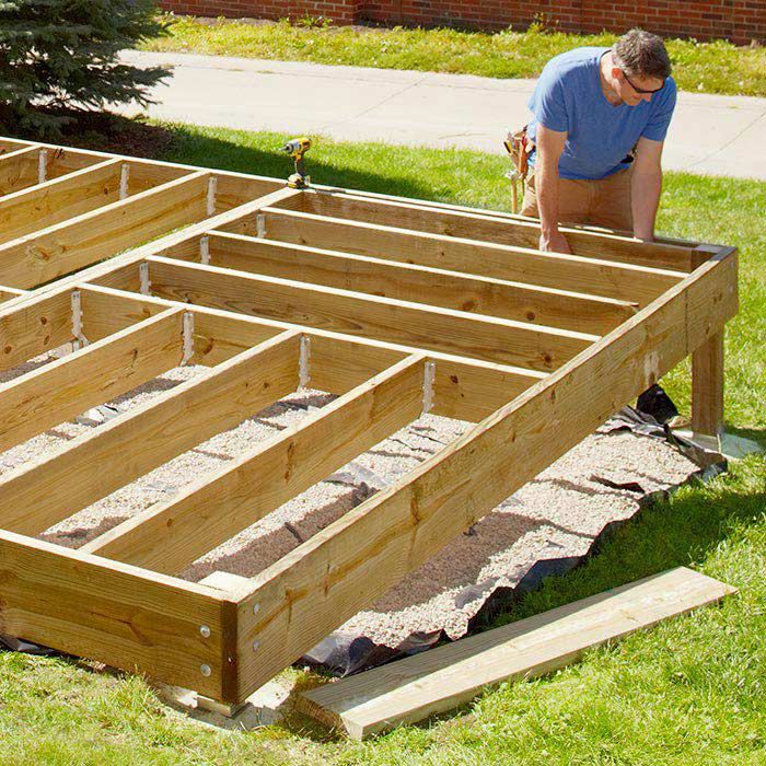 a man working on building a wooden deck