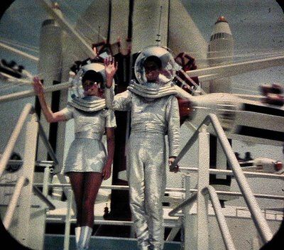 two women in silver space suits on a ship