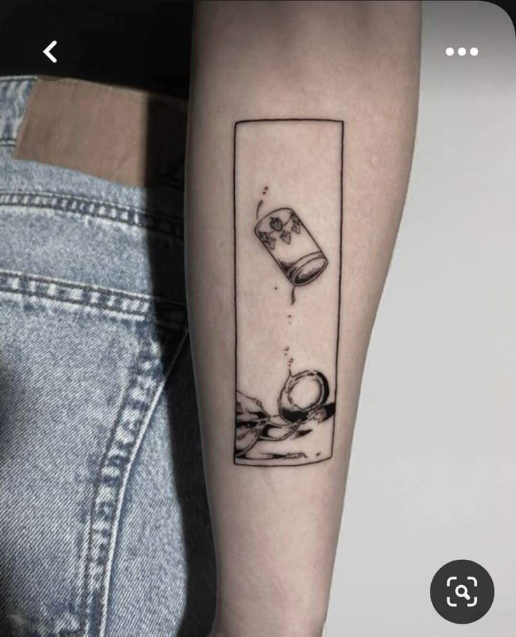 a person with a tattoo on their arm has a bottle and glass in the water