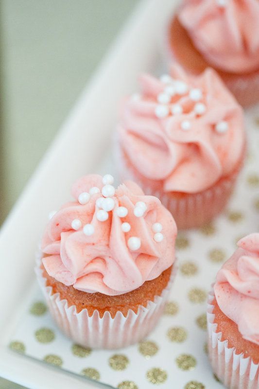 cupcakes with pink frosting and white sprinkles