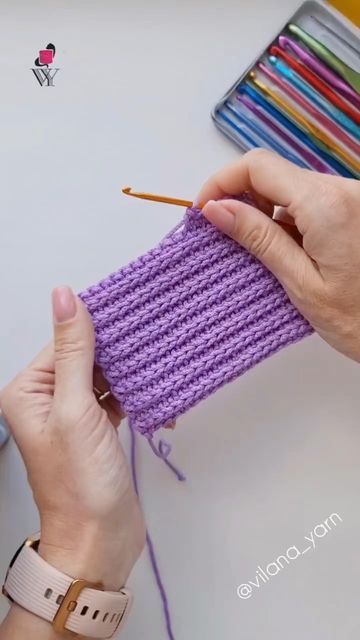 someone is knitting something on the table with crochet