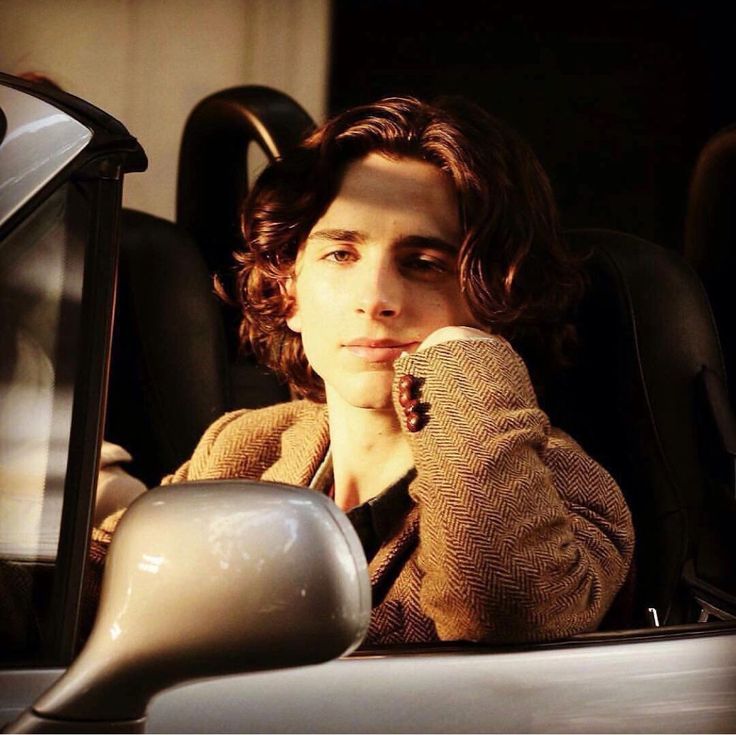 a woman sitting in the back seat of a car