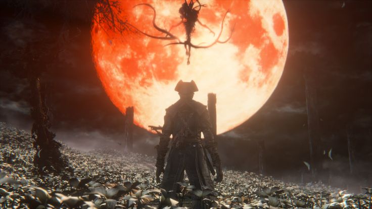 a man standing in the middle of a field with a giant red moon behind him