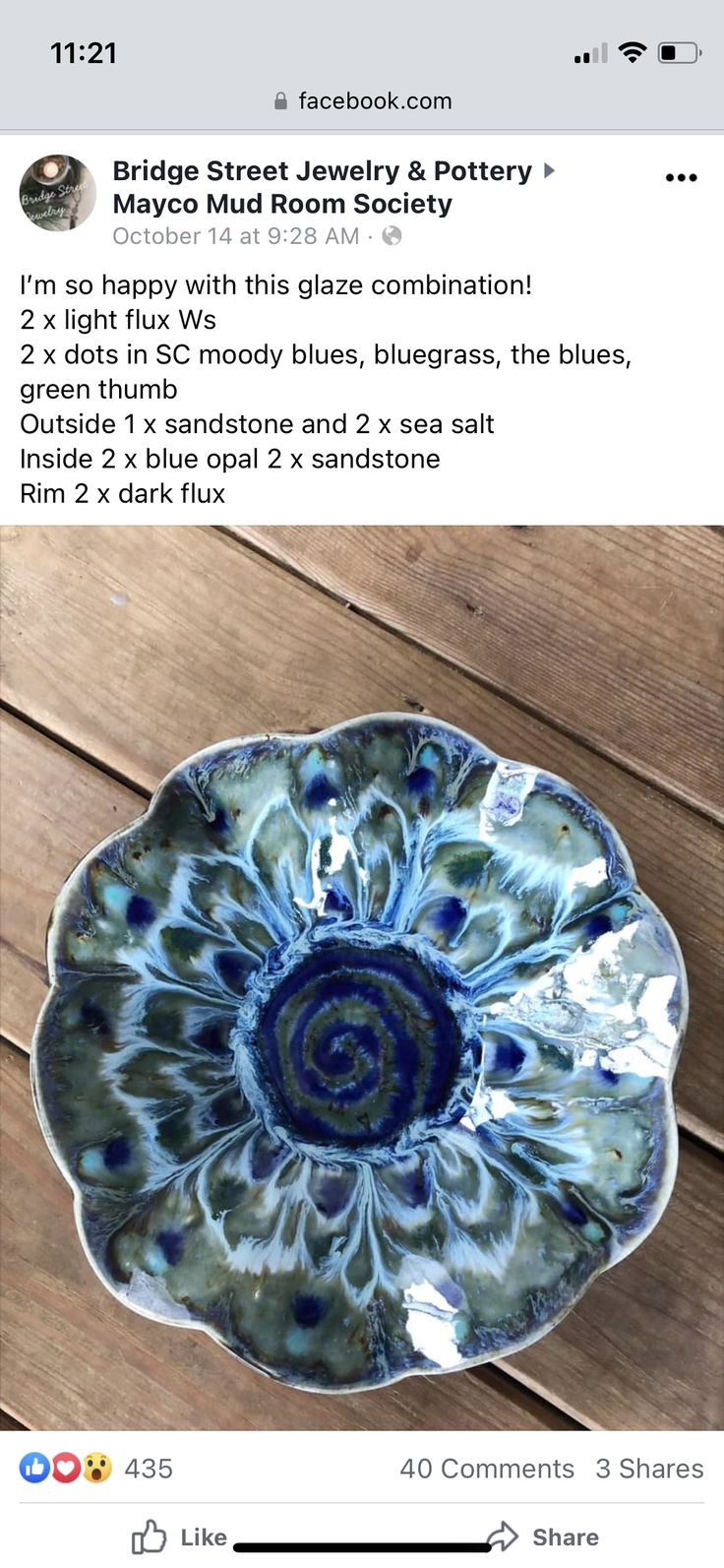 a blue and white bowl sitting on top of a wooden table next to a facebook post