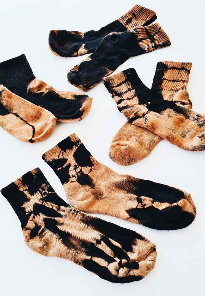 five pairs of socks that have been dyed with brown and black dyes on them