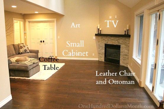 an empty living room with hardwood floors and white walls