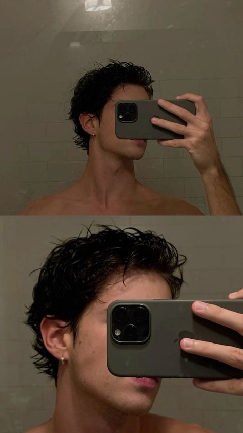 a man taking a selfie in the mirror with his cell phone and holding it up to his face