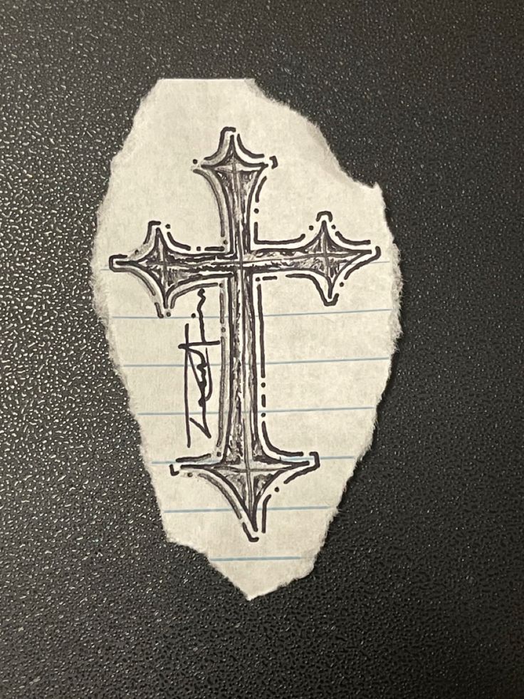 a piece of paper with a cross drawn on it