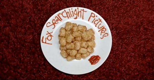 a white plate topped with food on top of a red carpeted floor next to a sign