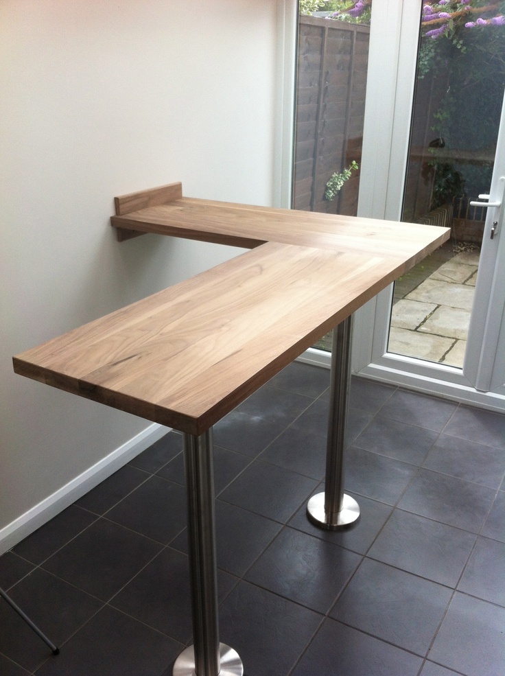 a wooden table sitting on top of a tiled floor