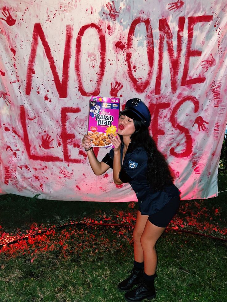 a woman holding up a box of cereal in front of a sign that says no one likes