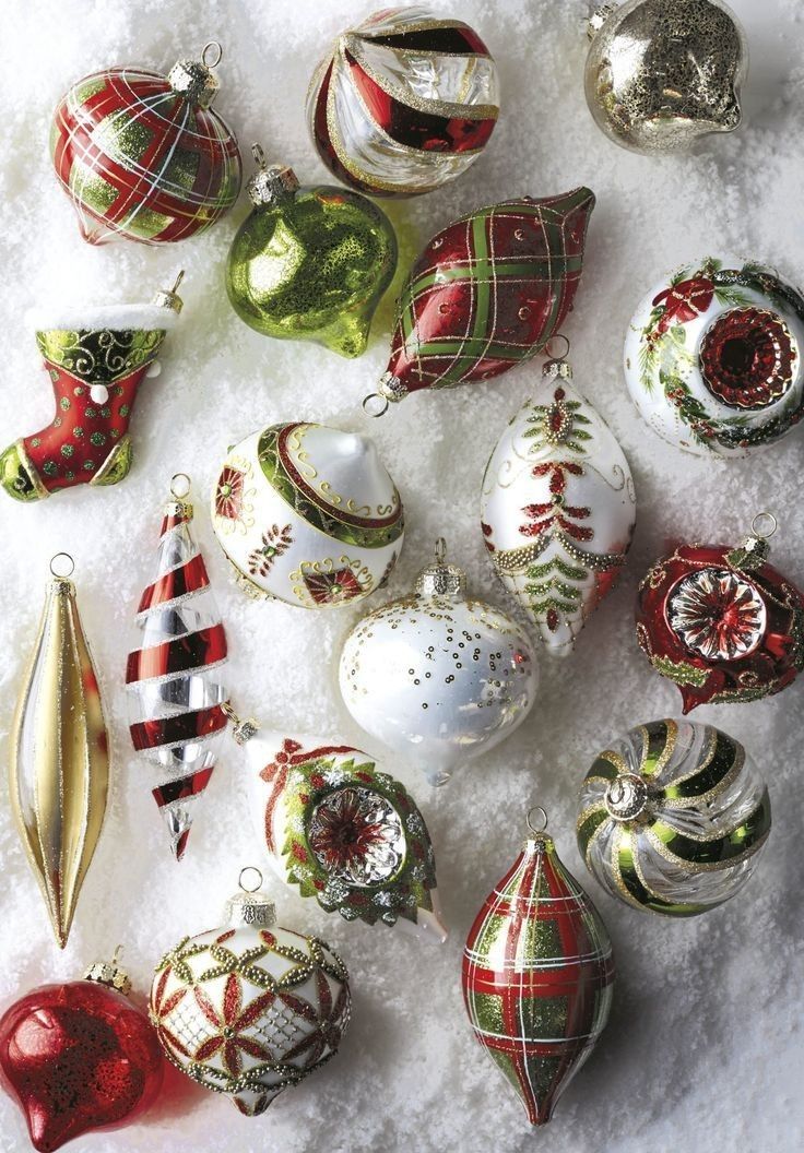 a collection of christmas ornaments sitting on top of snow