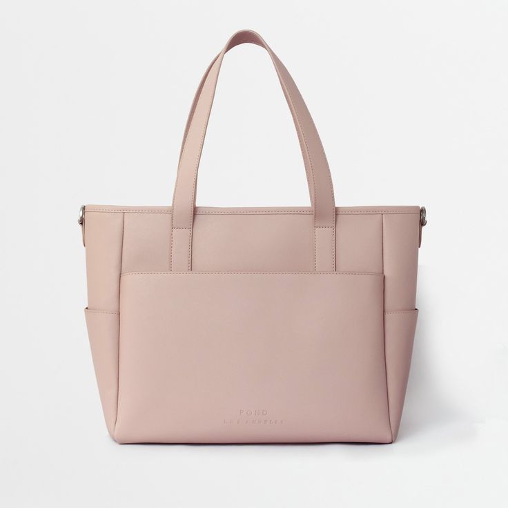 This structured leather tote is the perfect work bag, travel bag, and go anywhere bag. It features a spacious and organized interior for your essentials, a padded compartment for a 15 inch laptop (and 16 inch Macbook Pro), side pockets for your drinks, and you can convert it into a backpack or crossbody. Everyday Large Capacity Rectangular Diaper Bag, Pink Laptop Bag For Everyday Use, Modern Diaper Bag For Travel, Large Capacity Rectangular Diaper Bag For On-the-go, Versatile Rectangular Diaper Bag For Shopping, Modern Shoulder Diaper Bag For On-the-go, Modern Rectangular Diaper Bag With Removable Pouch, Functional Shopping Tote Diaper Bag, Modern Tote Diaper Bag For On-the-go