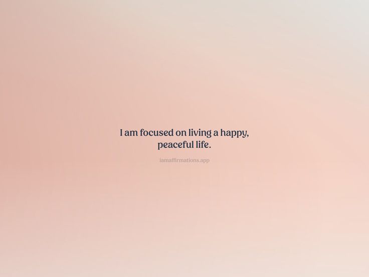 a pink and white wall with a quote on it that says i am focused on living a happy, peaceful life