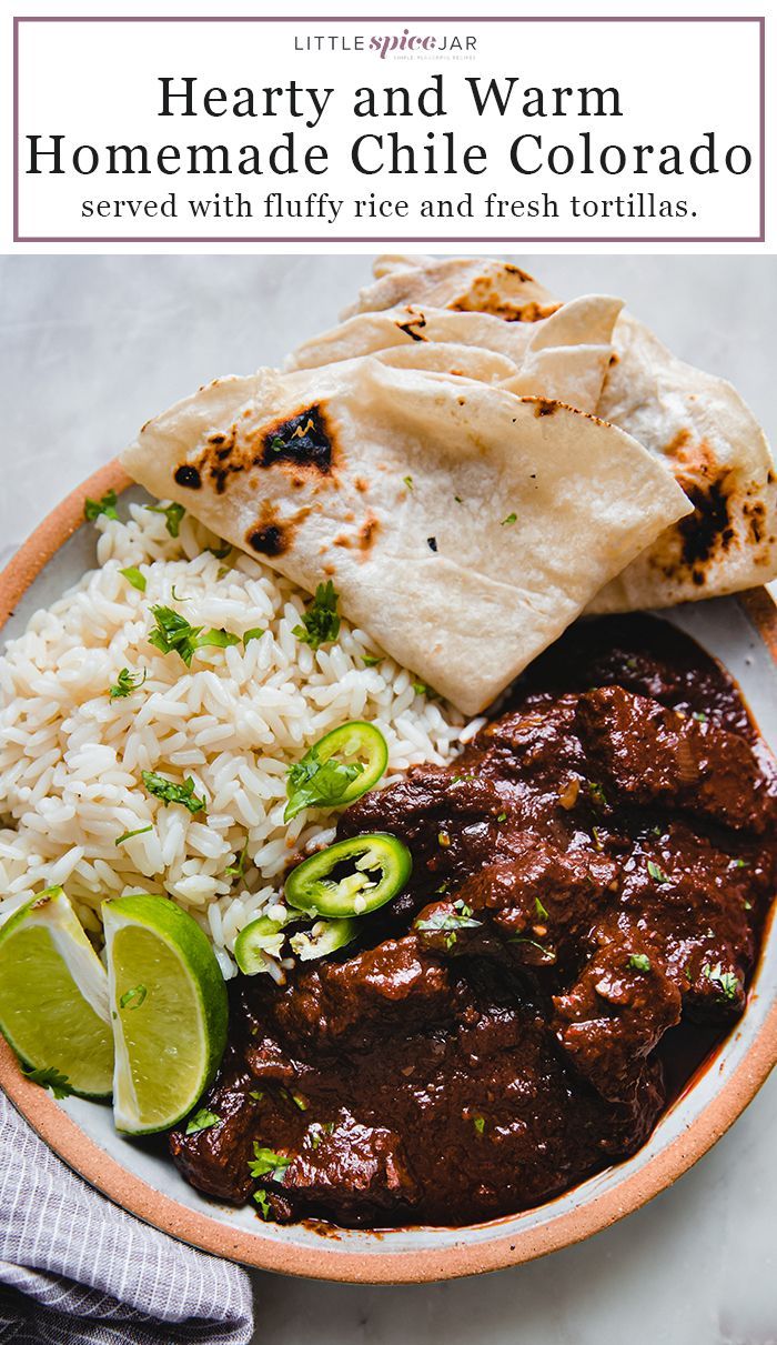 a bowl filled with rice, meat and tortillas next to lime wedges