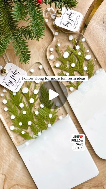 a pair of scissors sitting on top of a cutting board next to a christmas tree