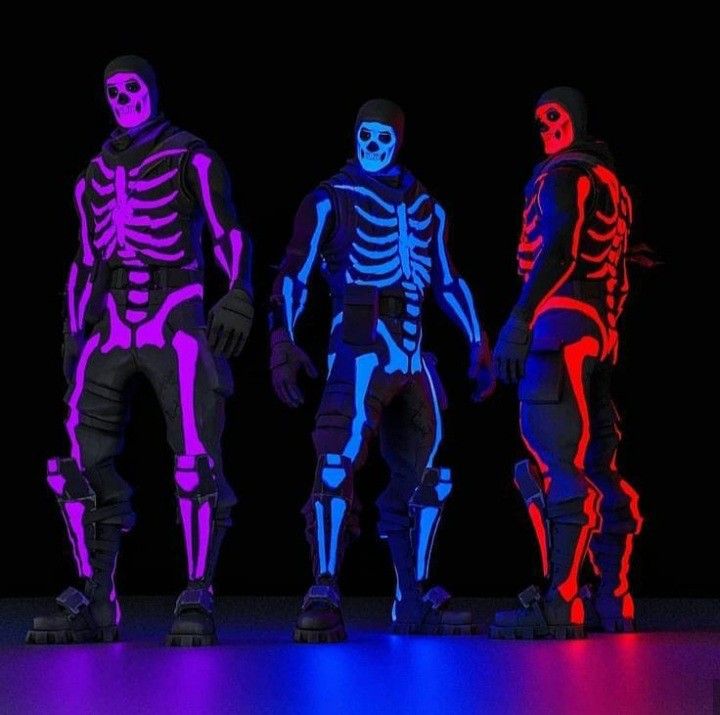 three men in skeleton costumes standing next to each other with neon colors on their bodies