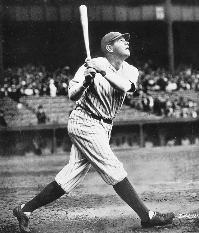 an old black and white photo of a baseball player with a bat in his hand