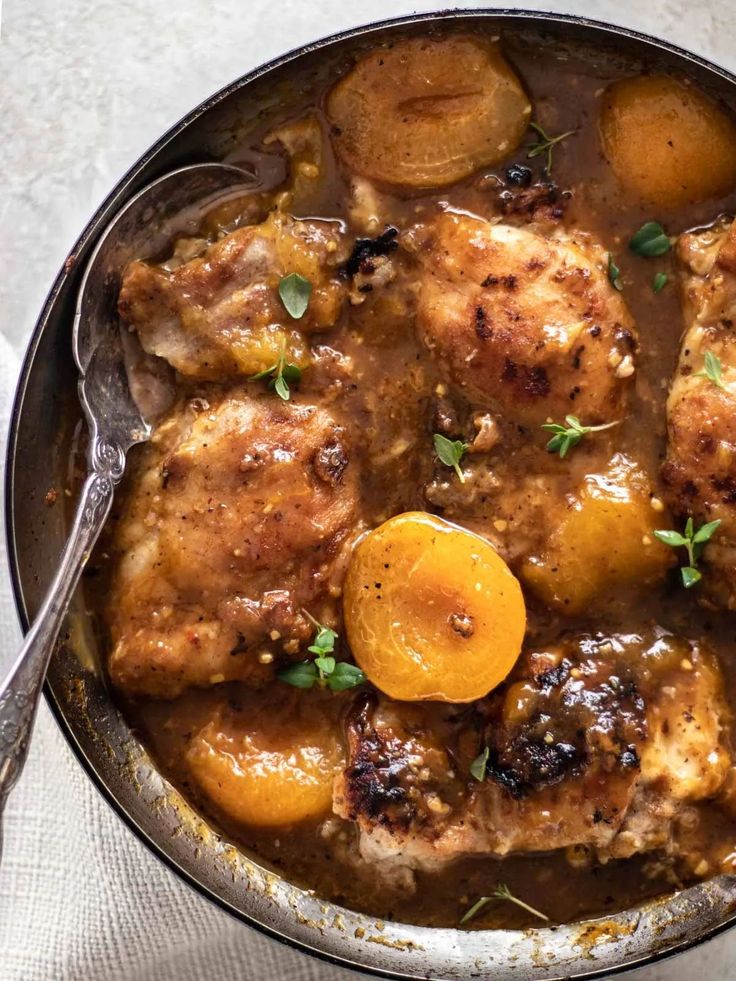 a pan filled with meat and potatoes covered in gravy