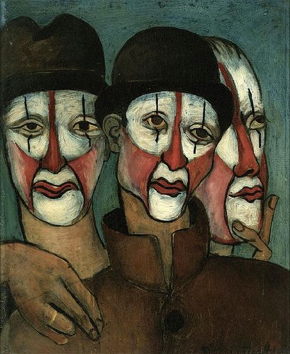 three men with painted faces are standing next to each other