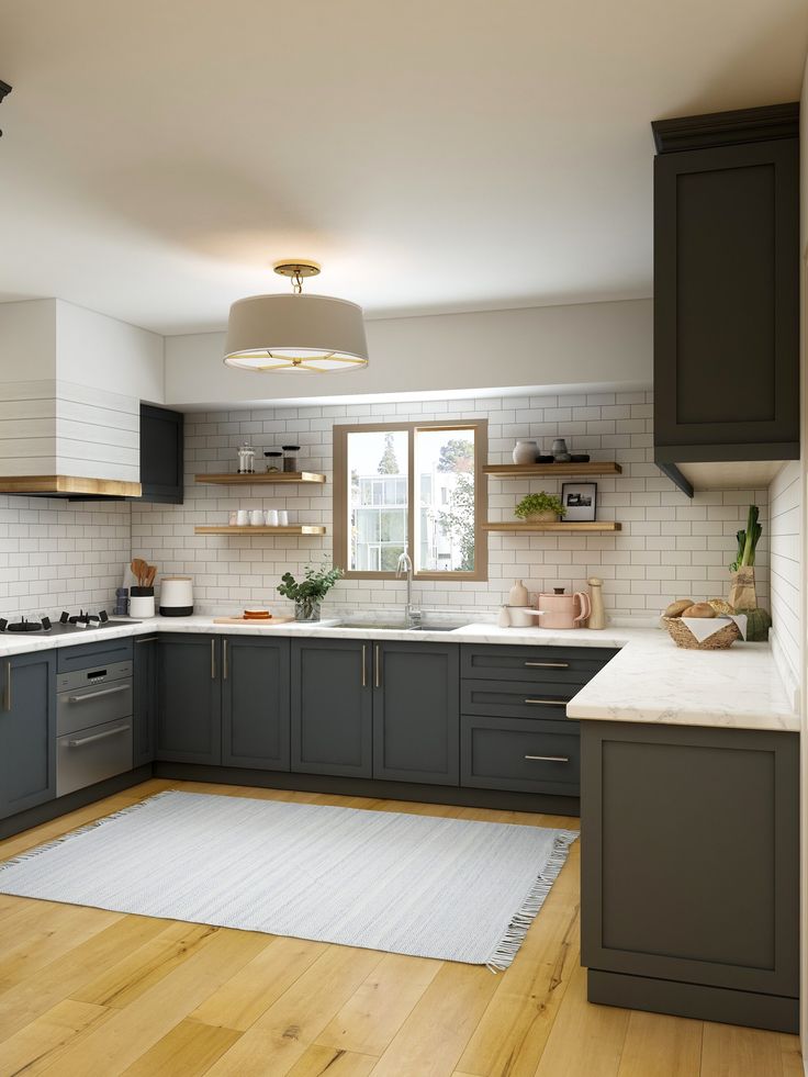 a kitchen with gray cabinets and white counter tops, wood floors and wooden flooring