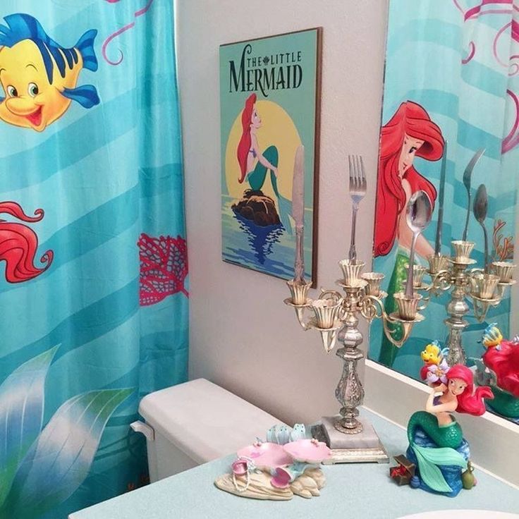 the little mermaid bathroom is decorated in blue and pink